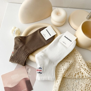 Japanese style combed cotton crew socks with heel embroidery in white and coffee brown