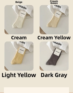 Detail of ribbed cotton mid-calf socks in six assorted colors with minimalist packaging