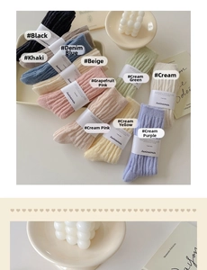 Flat lay of colorful ribbed winter socks in ten soft pastel tones with paper branding
