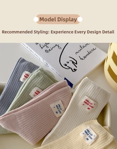 Detailed view of pastel ribbed cotton socks with decorative hello nice day textile labels