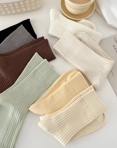 Detailed macro view showing the ribbed knit texture and six diverse colors of cotton socks
