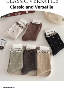 Polka dot crew socks with ruffle cuffs in various colors on a tray display