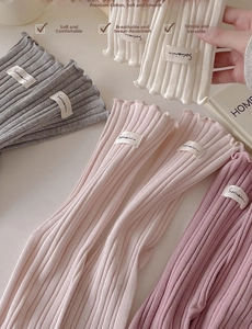 Close-up of combed cotton rib-knit socks featuring ruffled edges in various pastel colors