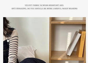 Detail of adjustable metal buckle on dark denim overalls with striped knit sweater