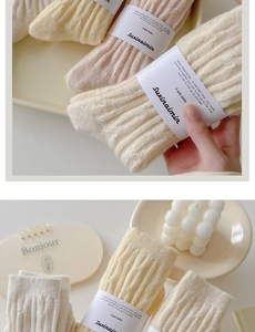 Detail of cream ribbed knit warm mid-calf socks with premium paper band packaging