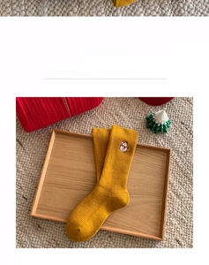 Detail of ginger cotton crew socks featuring snowman embroidery and ribbed knit texture