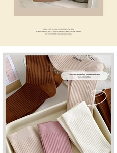 Close-up of ribbed cotton slouch socks in caramel, beige, and white tones
