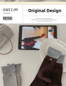 Detail of Korean style cotton striped socks with vintage buttons and blue cuff accents