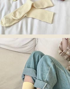 Close-up of cream ribbed cotton socks showing soft vertical knit texture and premium quality