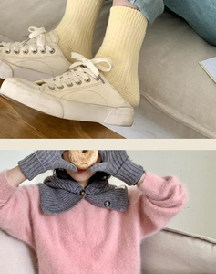 Winter outfit detail featuring ribbed yellow socks, canvas shoes, and knit accessories