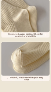 Detail of cream ribbed socks featuring reinforced heel and seamless flat toe stitching