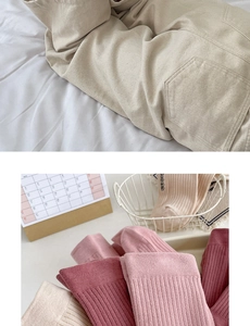 Detailed close-up of white cotton slouch socks with thick ribbing and textured knit fabric