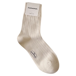 Ribbed combed cotton crew socks in cream white color with original paper packaging tag