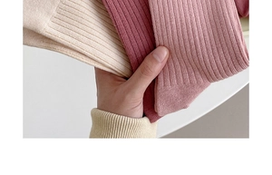 Close-up of elastic ribbed cotton fabric on soft mid-tube socks in white and pink tones