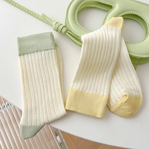 Vertical ribbed cotton crew socks in cream, yellow, and green contrast color design