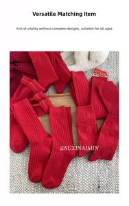 Detail showing various textures of red cotton socks like cable knit and checkered patterns