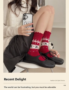 Detail of red cotton socks with white bear jacquard pattern and black split-toe Mary Janes