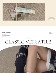 Detail view of cotton crew socks featuring white stripes and button accents at the cuff