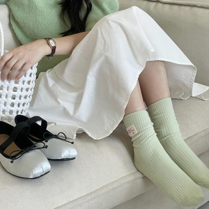 Light green ribbed mid-calf socks with Hello Nice Day label for a casual Japanese style
