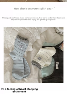Detail of cotton crew socks with blue stripes, bear patch and decorative ruffle edges