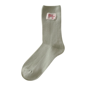 Japanese style light bean green cotton crew socks with vertical stripes and HELLO cloth tag