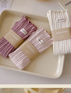 Detailed knit ribbed socks in purple, pink, and white with elegant rolled edges