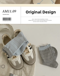 Close-up of striped cotton socks with ruffled edges and fashion design detail