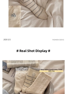 Detailed macro view of cream-colored Japanese style cotton socks with cherry embroidery