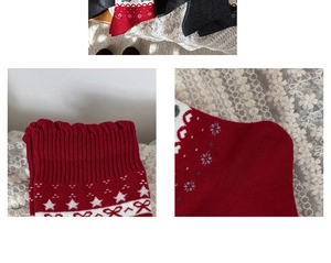 Detailed view of grey knit socks with festive snowflake patterns and wavy elastic cuffs