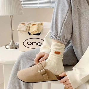 Beige suede mule with cream ribbed knit mid-calf socks and leather patch accent