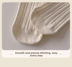 Close-up of seamless toe stitching on off-white ribbed cotton socks with soft texture