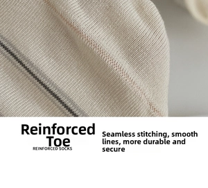 Detail of cream cotton socks featuring reinforced toe and smooth seamless stitching