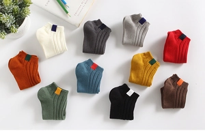 Detail of ten colorful ribbed cotton crew socks neatly arranged in a home decor setting