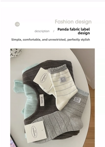 Detailed close-up of a striped mid-calf sock featuring an original panda fabric label