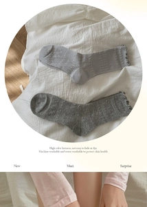 Detail of grey lace mesh cotton socks with breathable eyelet patterns and ruffled cuffs