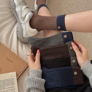 Retro ribbed mid-tube socks with decorative metal buttons in various vintage colors