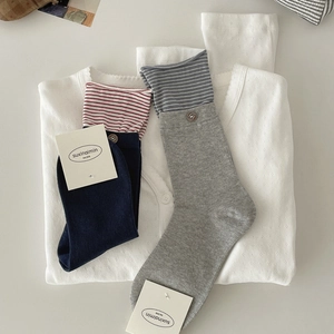 Striped cotton crew socks with vintage buttons and contrast colors in a flat lay view