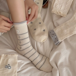 Cozy cream-colored mid-calf socks with cute Japanese embroidery patterns for women