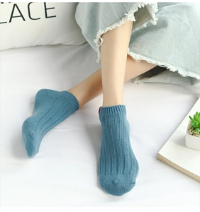 Close-up of fog blue ribbed cotton ankle socks with casual fabric label for women