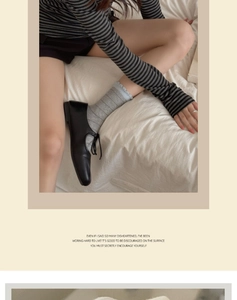 Detail of grey striped crew socks with ruffled edges paired with black lace-up shoes