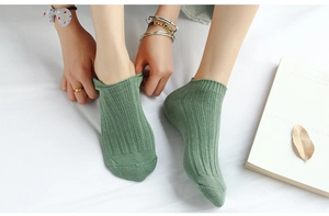 Detail of light green ribbed low-cut cotton socks showing the breathable knit texture