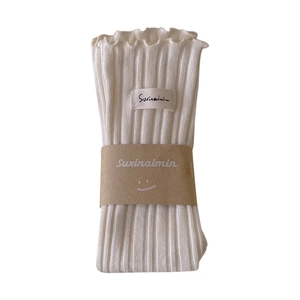 Sweet cream white ribbed cotton socks featuring elegant ruffle trim and minimal brand label
