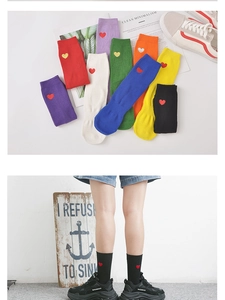 Détails de chaussettes en coton avec cœur brodé, texture côtelée et couleurs vives