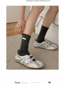 Detailed view of dark grey ribbed socks with white polka dots and 'I dig you' label