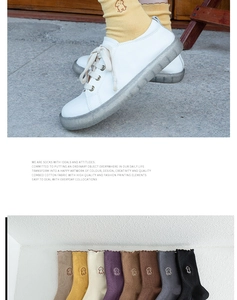 Detail of combed cotton mid-tube socks featuring cute dog embroidery and ruffled edges