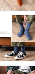 Close-up of ribbed cotton socks in denim blue and burnt orange with soft knit texture