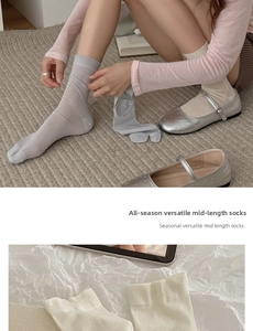 Detail of breathable mulberry silk tabi socks with split-toe design in grey and beige tones