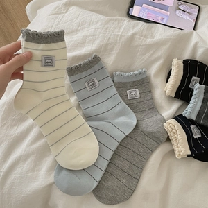 Japanese style striped crew socks for women featuring cute panda patches and wavy cuffs