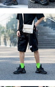 Detail of neon green cotton crew socks styled with black shorts and street sneakers