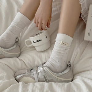 White cotton mid-calf socks with black polka dots and letter labels for a casual look